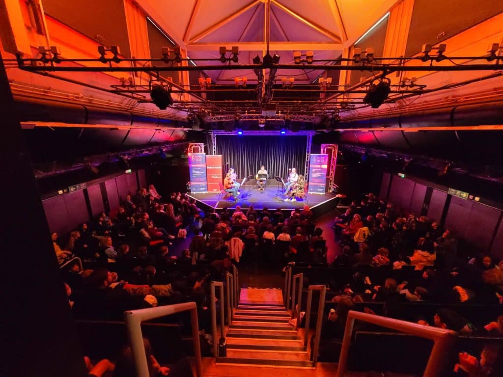 Young people are watching musicians perform in a church.