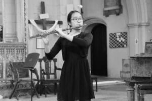 Young person playing the flute in a church