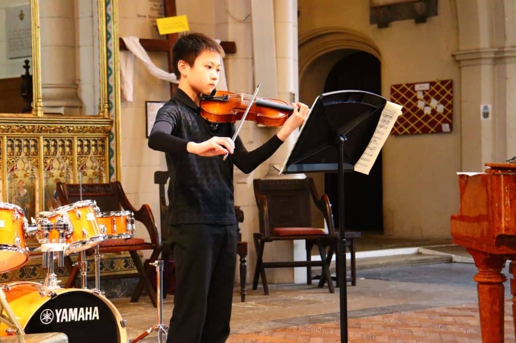 Young person performing on the violin