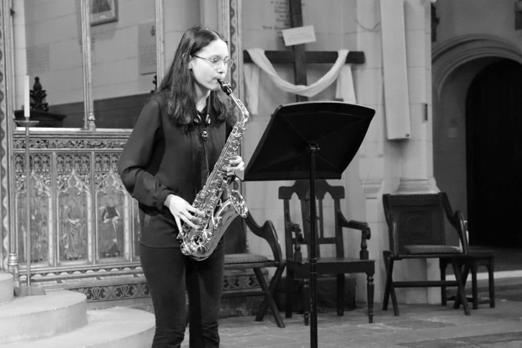 Young person performing on the saxophone