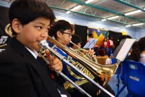 A photo of a trombone player in a school hall