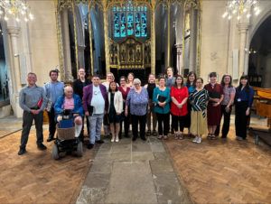 A group of adults standing in a church after a concert