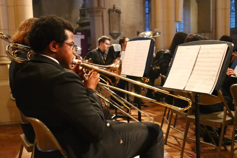 a student playing Trombone in a church