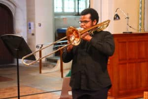 a student playing Trombone in a church