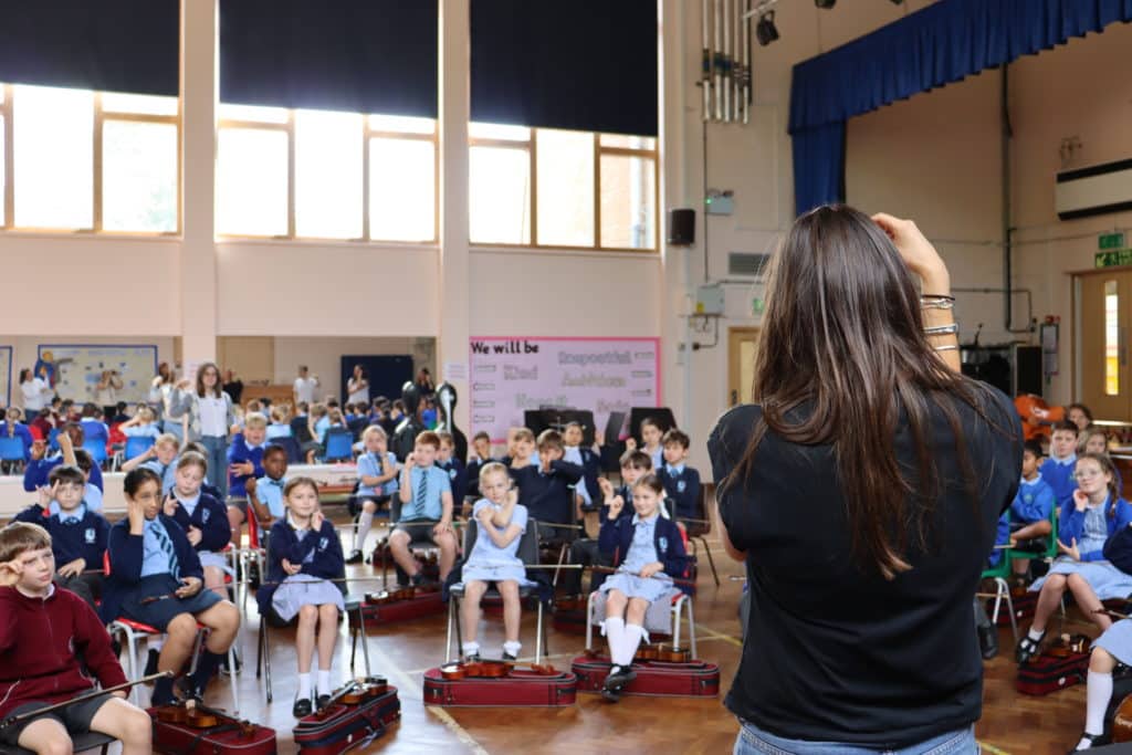 A group of students participating in a workshop in a school hall