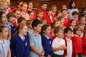 A group of children singing in a church