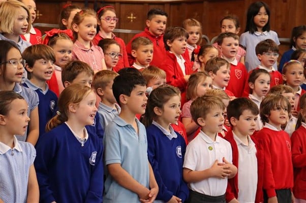 A group of children singing in a church