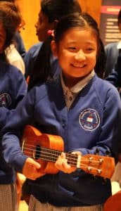 Image of a child playing a ukulele