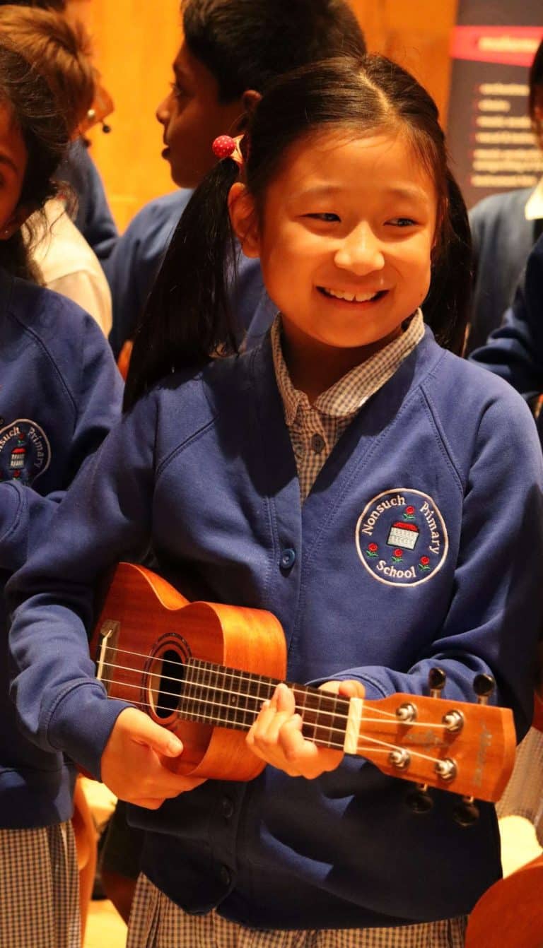 Image of a child playing a ukulele