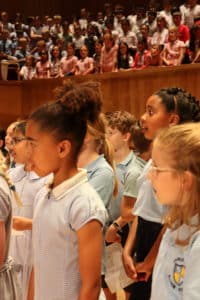 Image of a group of children singing on stage