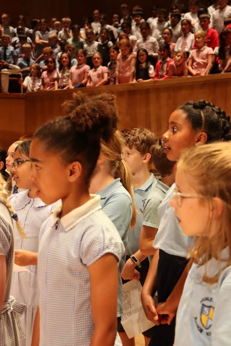 Image of a group of children singing on stage