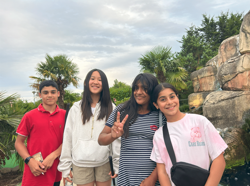 4 students pose at a mini golf course