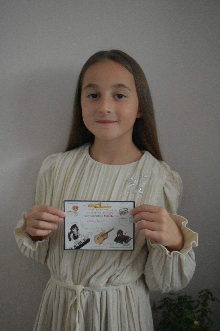 A student poses with a postcard