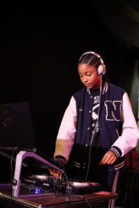 A student on stage, DJ'ing