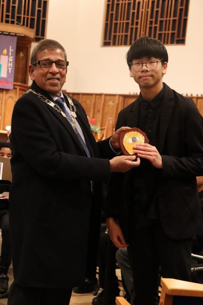 Student receives a plaque in a church