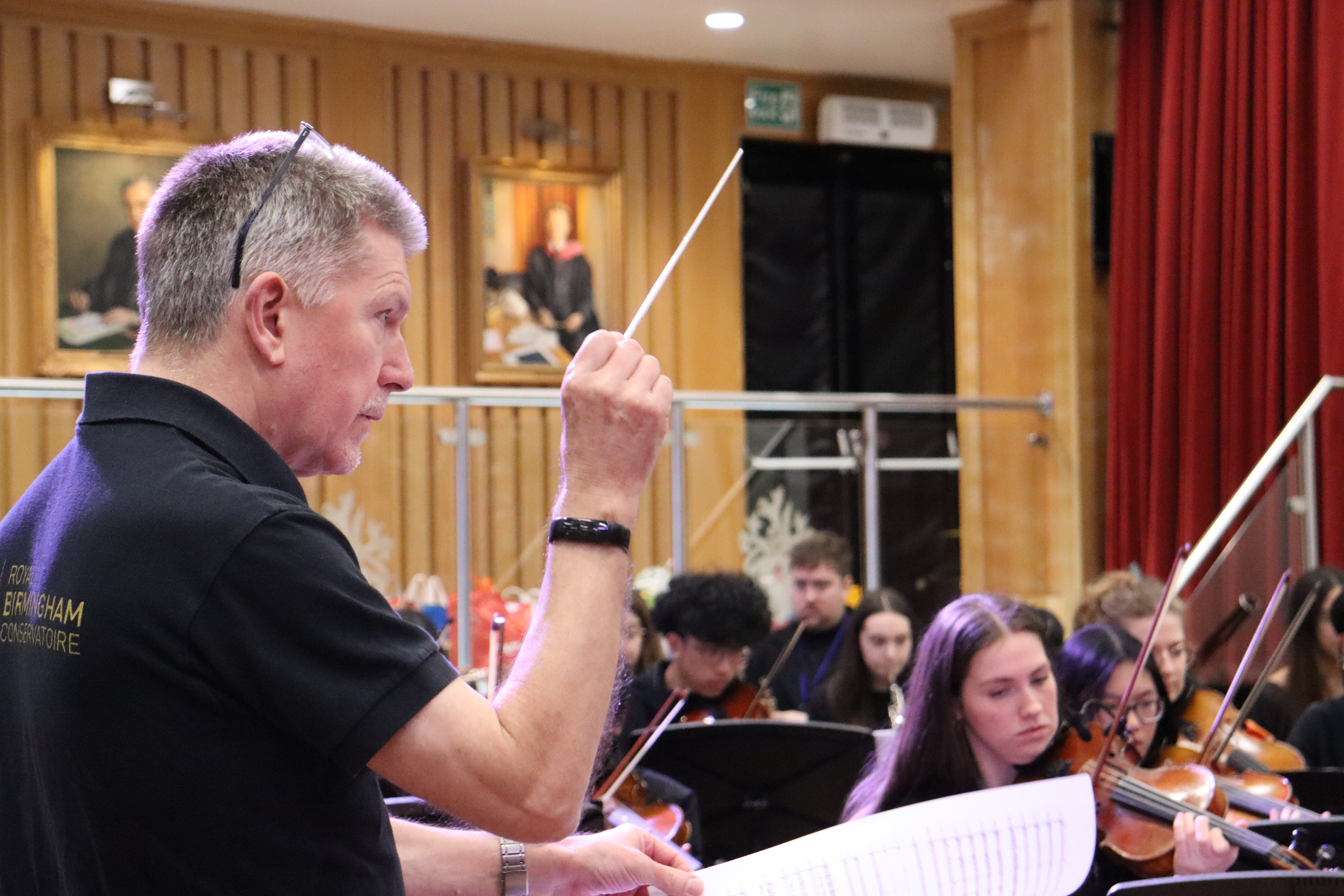 A conductor leading musicians in an orchestra
