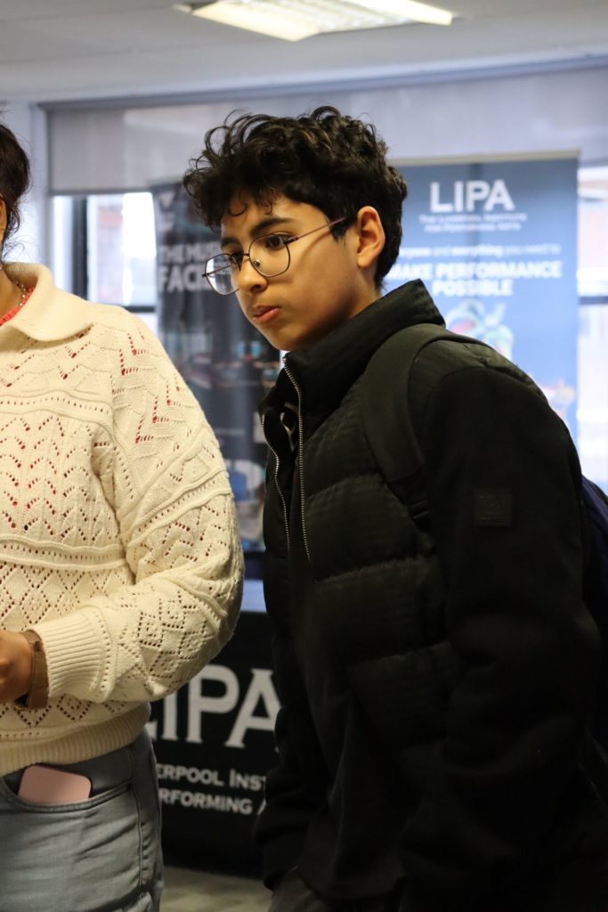 A student listens attentively to a stall holder