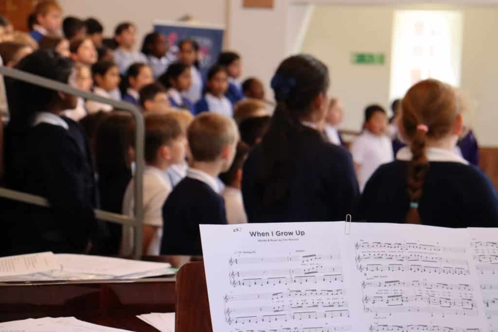 Picture of backs of students heads and a piece of sheet music